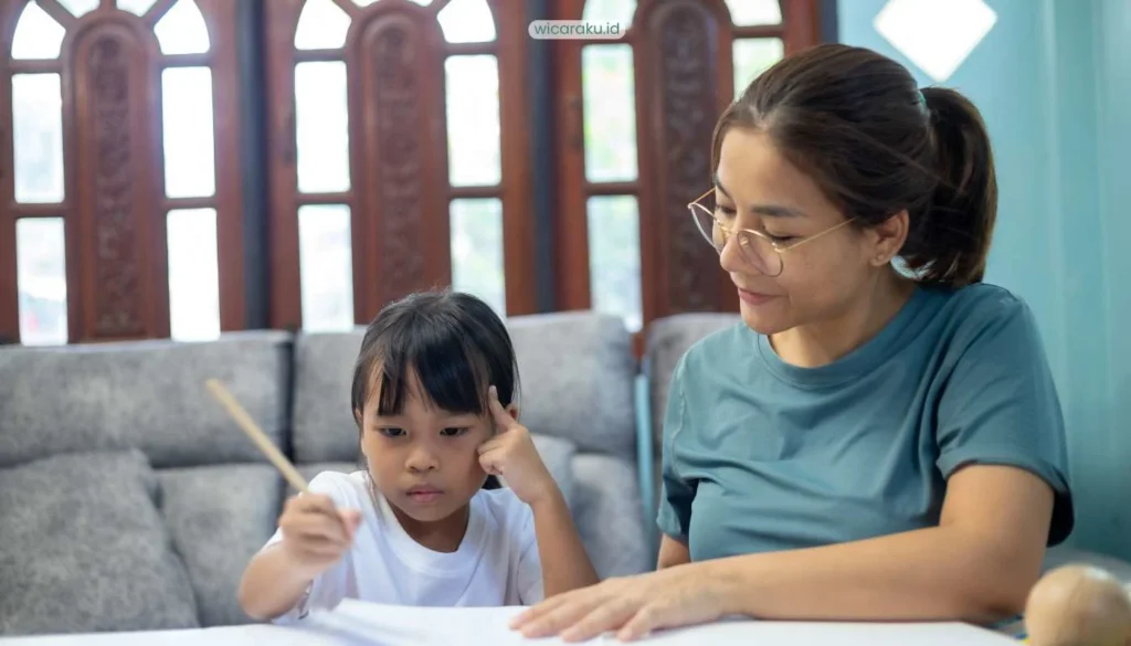 Terapis wicara anak sedang memberi arahan kepada seorang anak
